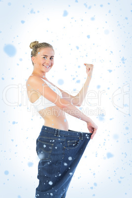 Confident triumphant blonde wearing too big trousers