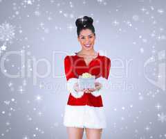 Composite image of pretty santa girl offering gift