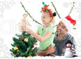 Cute little girl decorating the christmas tree with her father