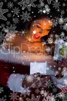 Pretty brunette in santa outfit opening gift