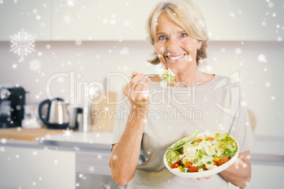 Composite image of smiling woman eating salad