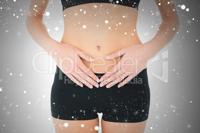 Closeup mid section of a fit woman with stomach pain