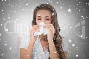 Composite image of attractive brunette blowing her nose