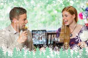 Composite image of cheerful couple eating together