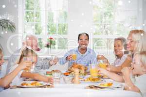 Composite image of family toasting at thanksgiving