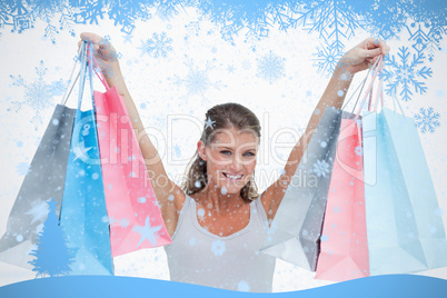 Composite image of woman holding shopping bags