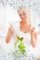 Composite image of portrait of a smiling woman mixing a salad