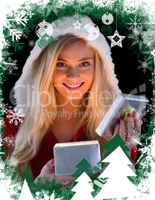 Pretty blonde in santa outfit opening gift