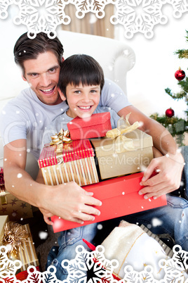 Happy father and son holding christmas presents