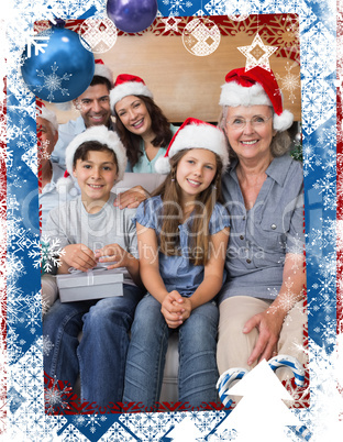 Extended family in christmas hats with gift boxes in living room