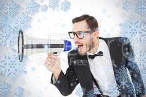 Geeky businessman shouting through megaphone