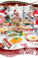 Happy family in santas hats enjoying christmas dinner