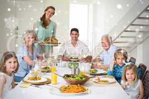 Composite image of family having meal at dining table