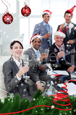 Manager and his team with novelty christmas hat toasting at a pa