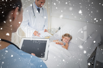 Composite image of doctors attending sick girl