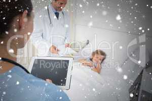 Composite image of doctors attending sick girl