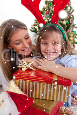 Composite image of smiling mother and her daughter holding chris