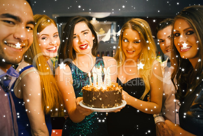 Happy friends celebrating brithday one holding birthday cake