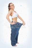 Composite image of cute woman wearing too big blue jeans