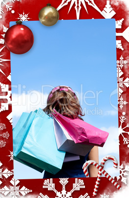 Smiling woman holding shopping bags outdoor