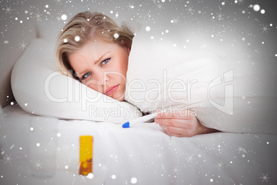 Composite image of sick blonde woman with a thermometer