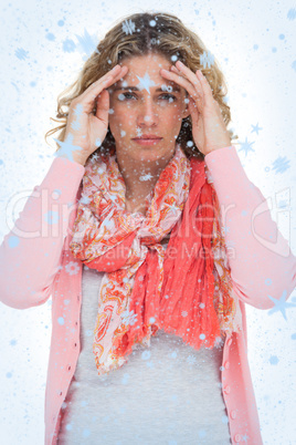 Composite image of blonde woman touching her temples because of a headache