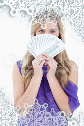 Composite image of blonde woman hiding her face behind a fan of