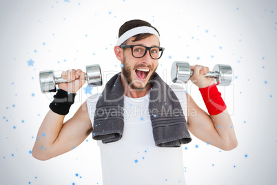 Geeky hipster lifting dumbbells in sportswear