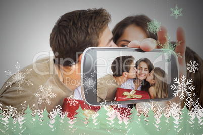 Hand holding smartphone showing photo