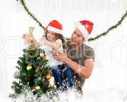Cute daughter decorating the christmas tree with his father