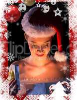 Pretty woman in santa outfit opening a gift smiling at it