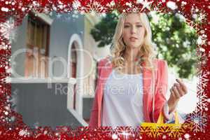 Composite image of pretty blonde holding shopping bags