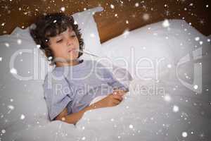 Composite image of sick child with thermometer resting in bed