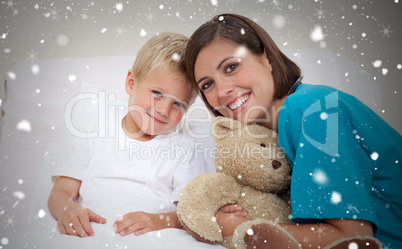 Smiling female doctor with her patient holding a teddy bear