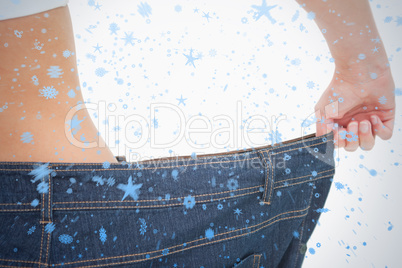 Close up of a woman waist in a too big pants