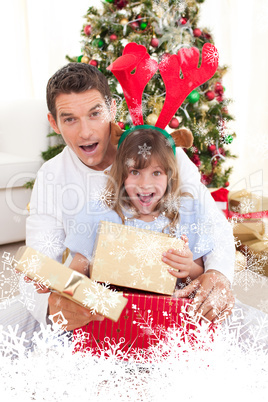 Composite image of surprised father and his girl opening christm