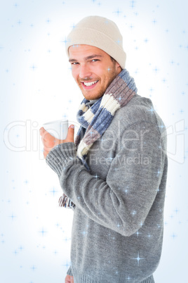 Handsome man in winter fashion holding mug