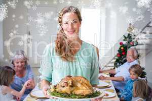 Composite image of smiling mother with christmas meal