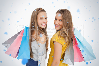 Two young women with shopping bags