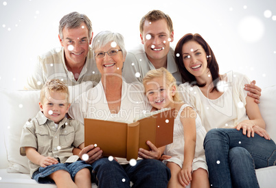 Composite image of grandmother reading a book to her children an