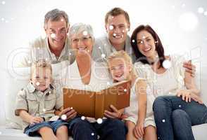Composite image of grandmother reading a book to her children an