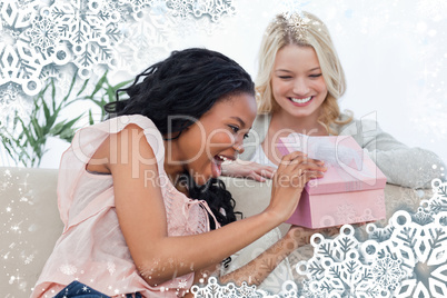 Delighted woman looks at a present given to her by a friend