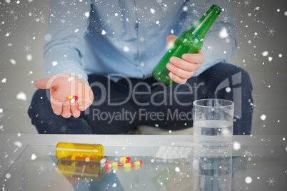 Close up of man showing pills and holding bottle