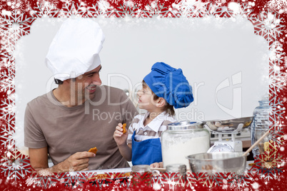 Smiling father and son eating homemade cookies