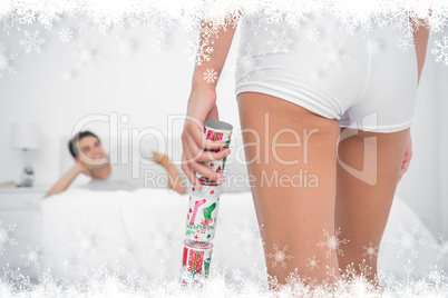 Composite image of sexy woman bringing christmas cracker to her