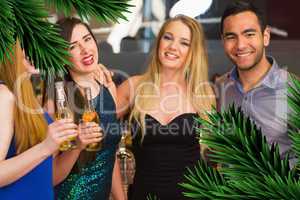 Portrait of smiling friends drinking beers