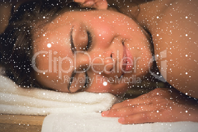 Happy brunette lying in a sauna