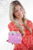 Composite image of young woman giving a gift