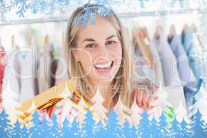 Composite image of cheerful woman standing in a clothing store