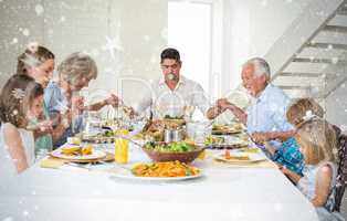 Composite image of family praying together before meal at dining